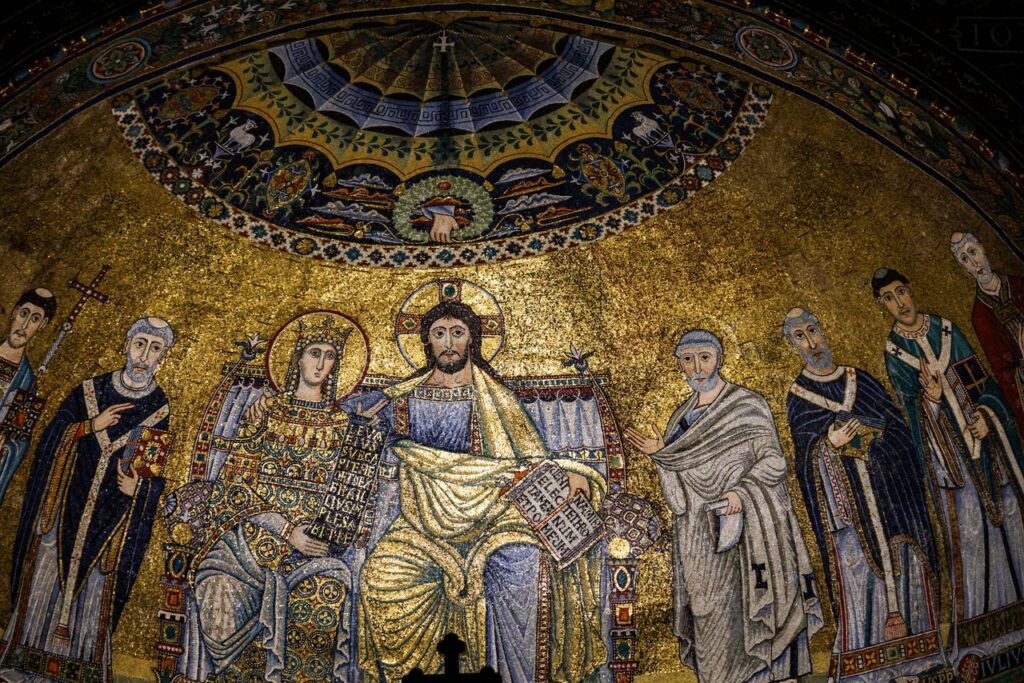 Intricate mosaic art depicting religious figures in a historic church interior. Credo Niceno